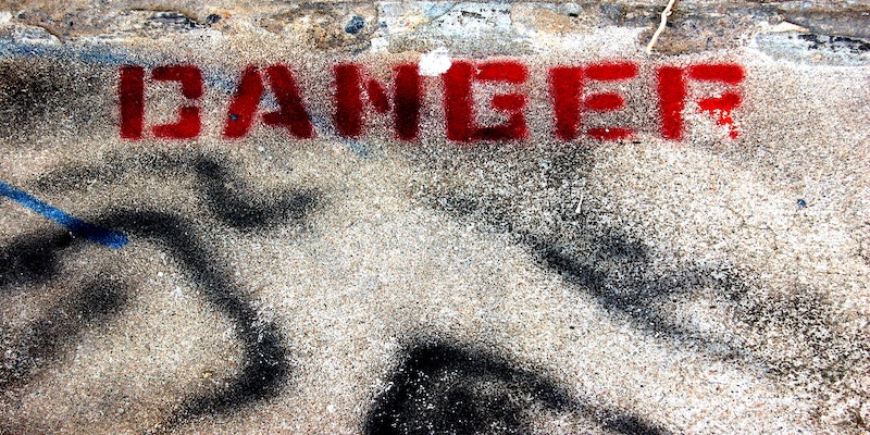 danger notice painted on ground