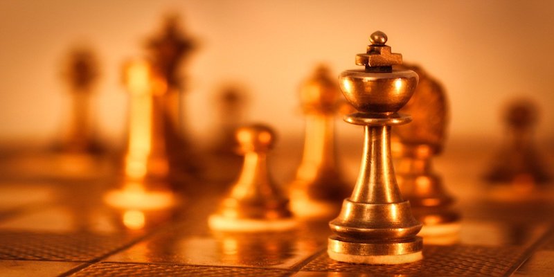 blurry chess board with king in focus to signify leadership