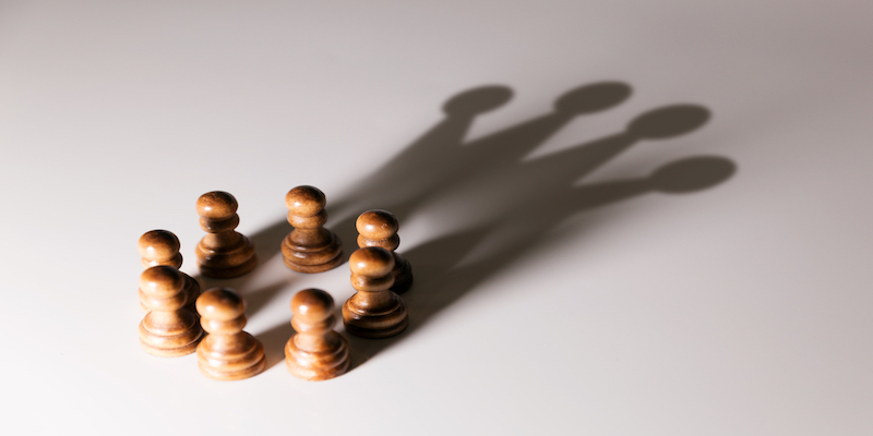 chess pieces grouped together for teamwork