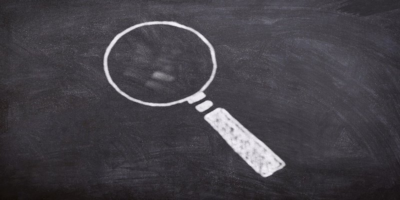 drawing of magnifying glass on chalkboard